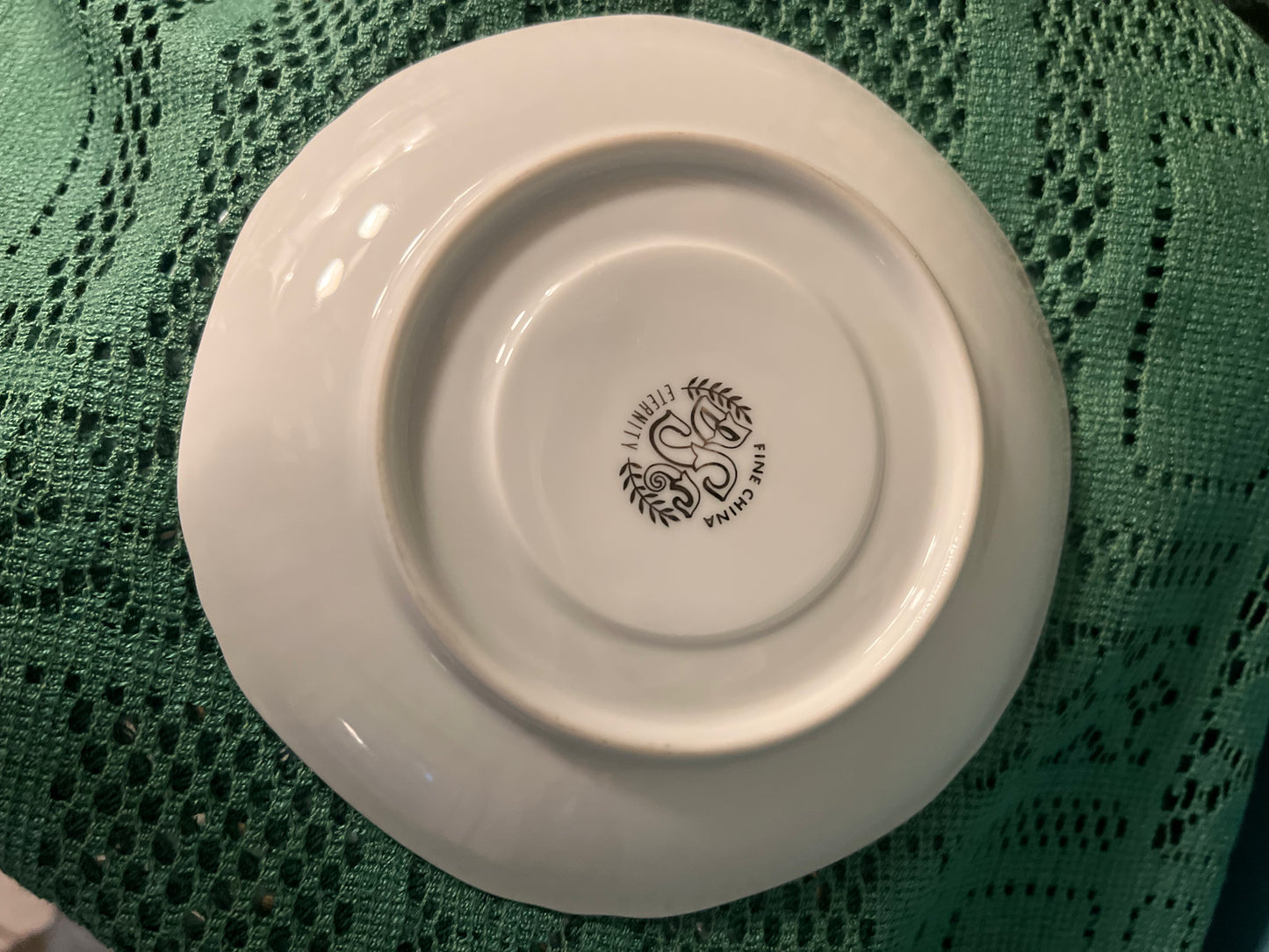 White china tea cup with embossed edge and platinum detail