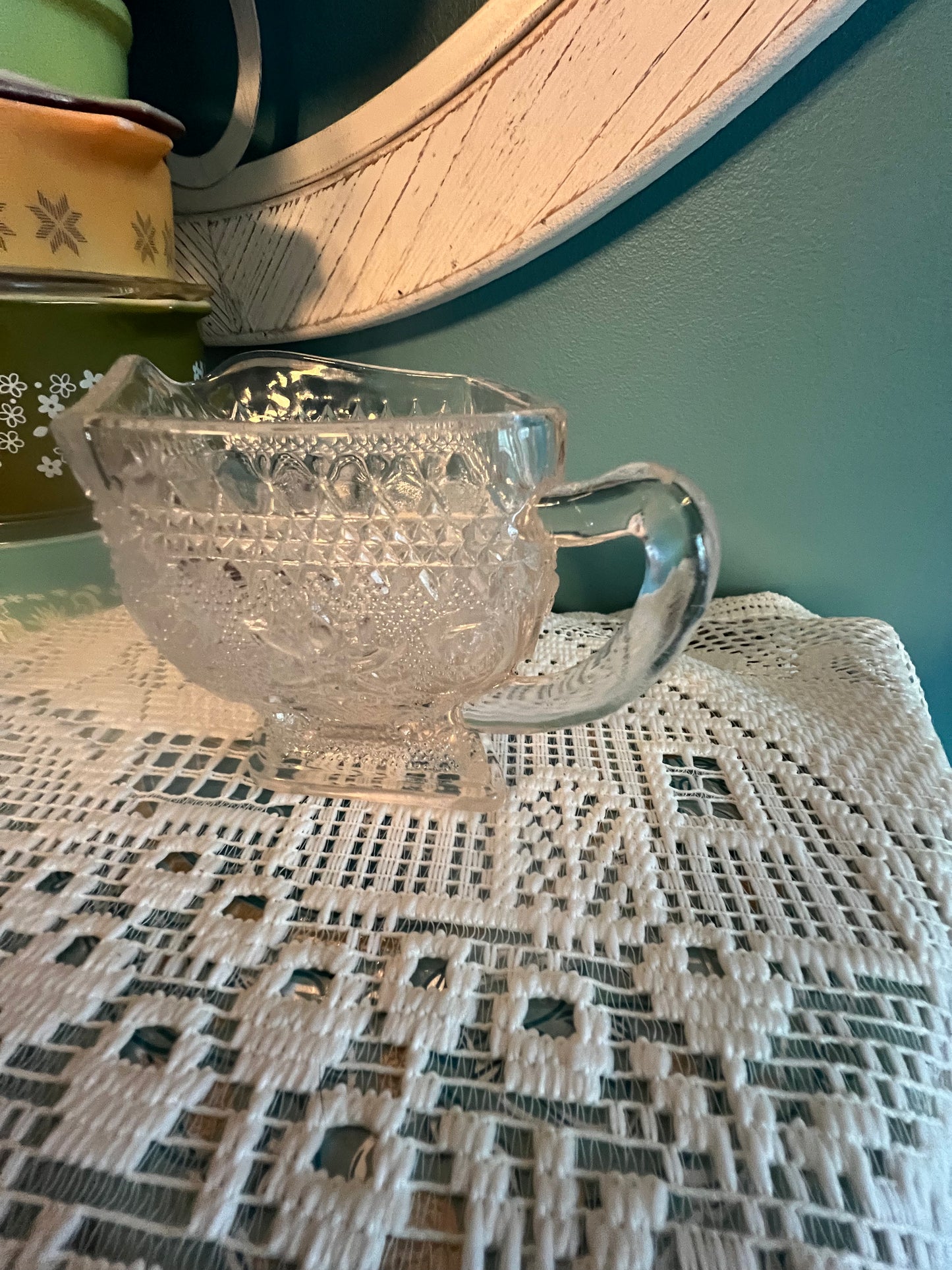 Pressed glass floral and scroll design creamer