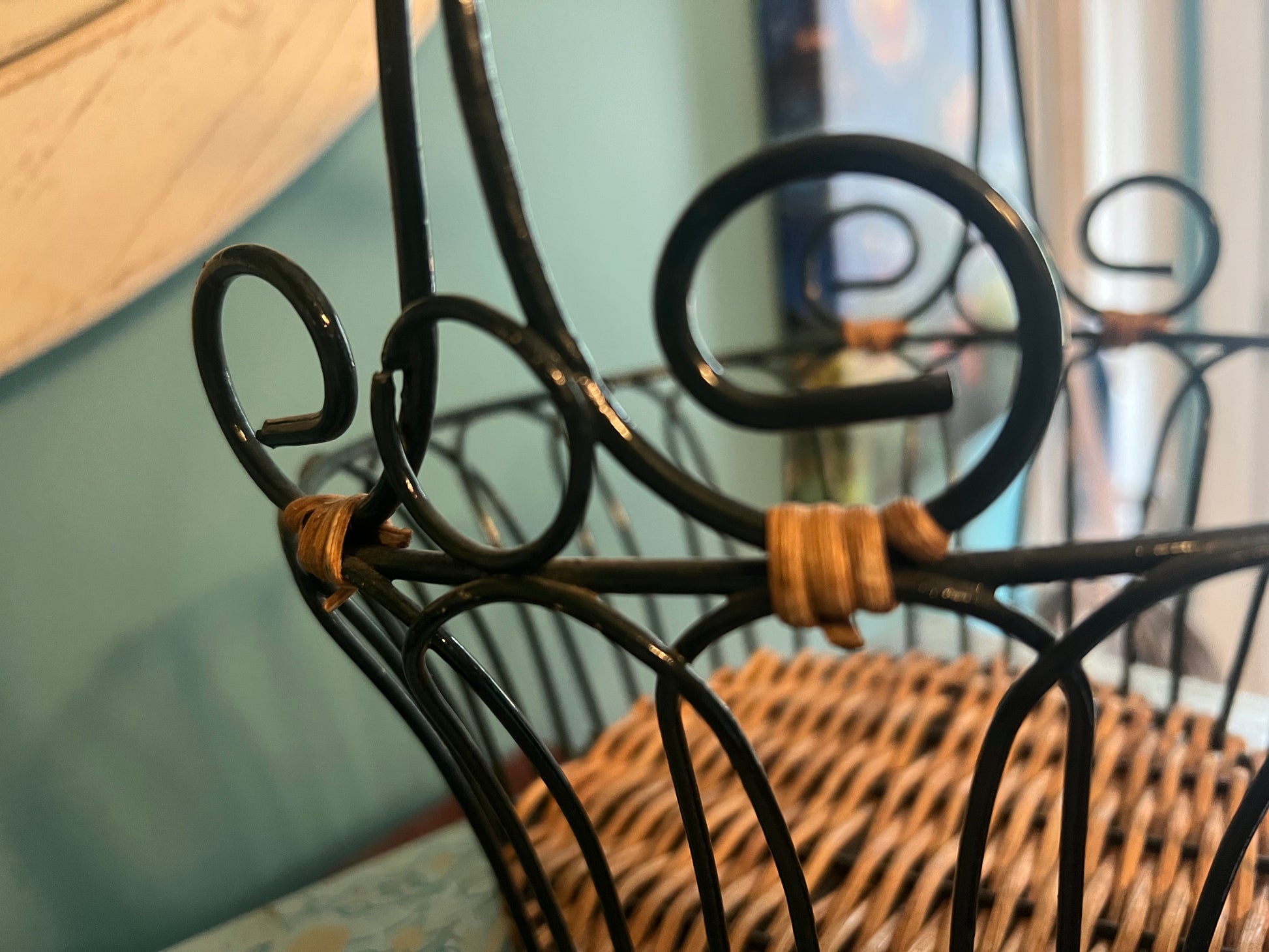 Small vintage green metal and wicker basket for rustic kitchen or home décor